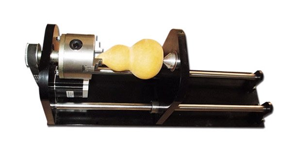 Co2 laser machine engraving bottles with a rotary